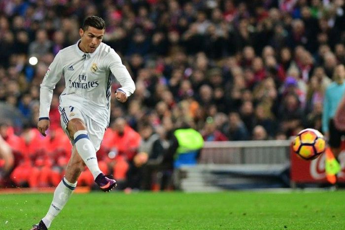 Real Madrid's Cristiano Ronaldo scores during the match agaisnt Club Atletico de Madrid on November 19, 2016