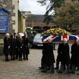 Rita Taylor (L), the wife of former England manager and manager of Watford football club Graham Taylor watches as his coffin is brought into church during his funeral service in Watford on February 1, 2017