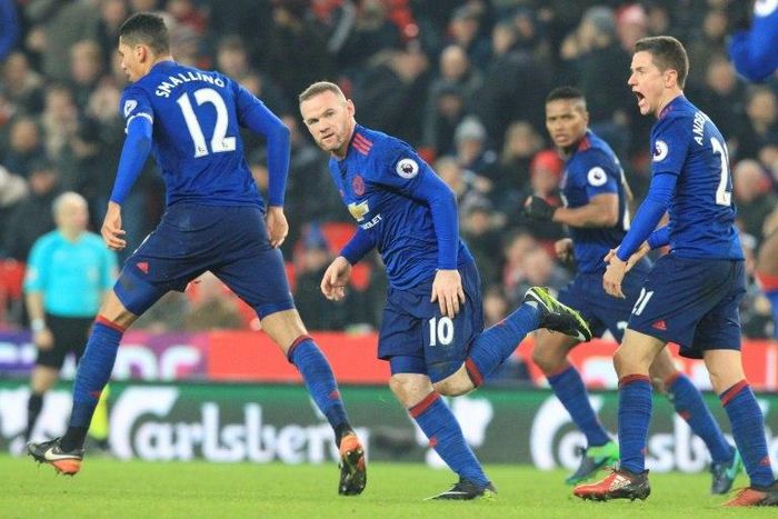 Manchester United's striker Wayne Rooney (C) celebrates scoring his 250th goal to make him the club's all-time record goal scorerer in the English Premier League football match between Stoke City and Manchester United on January 21, 2017