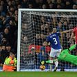 Everton's defender Leighton Baines (L) scores his penalty past the diving Manchester United's goalkeeper David de Gea during the English Premier League football match between Everton and Manchester United at Goodison Park on December 4, 2016