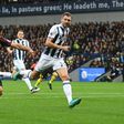 Manchester City's striker Sergio Aguero (L) shoots to score the opening goal of the English Premier League football match between West Bromwich Albion and Manchester City at The Hawthorns stadium in West Bromwich, central England, on October 29, 2016