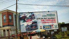 This photo taken on June 10, 2016 shows an advertising board concerning the oil pipeline vandalization in the City of Warri in Delta State