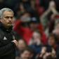 Manchester United manager Jose Mourinho points at the club badge as he leaves the pitch after his side's English Premier League win over Chelsea at Old Trafford in Manchester, north-west England, on April 16, 2017
