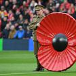 A giant poppy is displayed during a minute's silence in honour of Remembrance Day during the English Premier League football match between Liverpool and Watford at Anfield in Liverpool, north west England on November 6, 2016