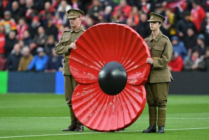 A giant poppy is displayed during a minute's silence in honour of Remembrance Day during the English Premier League football match between Liverpool and Watford at Anfield in Liverpool, north west England on November 6, 2016