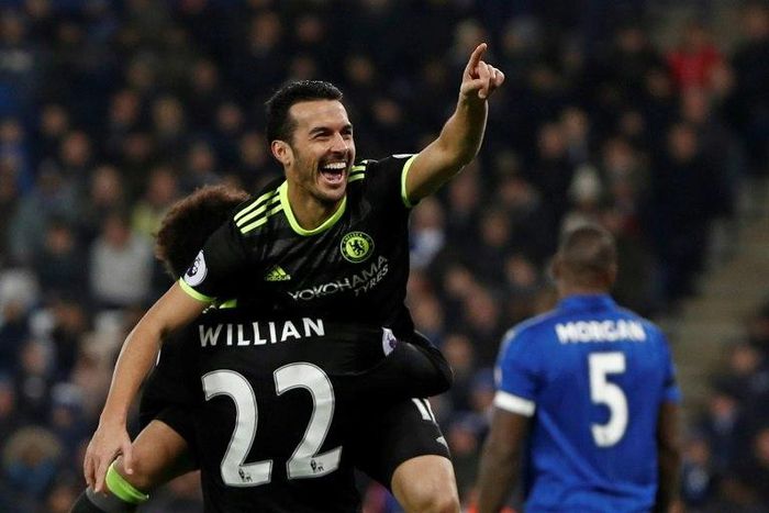 Chelsea's midfielder Pedro celebrates in the arms of midfielder Willian after scoring their third goal during the English Premier League football match between Leicester City and Chelsea on January 14, 2017