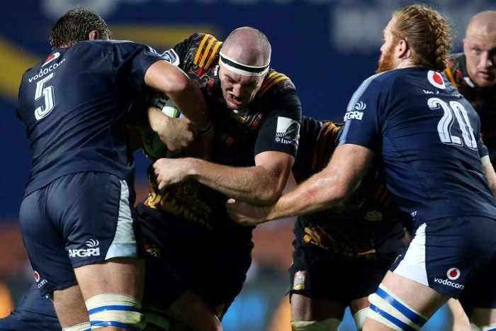 Waikato Chiefs' Brodie Retallick (centre) is tackled by Northern Bulls' Lood De Jager (left) and Jannes Kirsten during their Super Rugby clash in Hamilton, on April 1, 2017