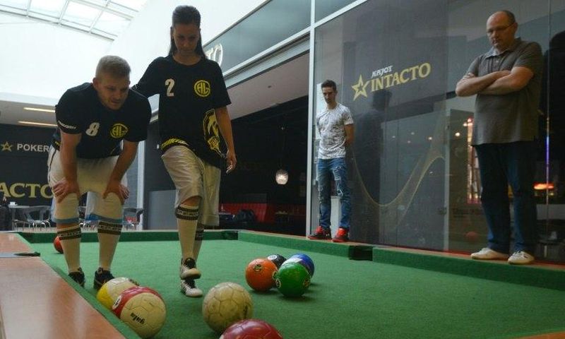 Footballpool is a combination of football and pool; the sport uses inflatable footballs - white, solids and stripes like in pool - and a playground with six holes, proportionally larger than the regular pool table