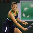 Karolina Pliskova of the Czech Republic plays a backhand against Garbine Muguruza of Spain on her way to a 7-6 (7/2), 7-6 (7/5) quarter final win at Indian Wells