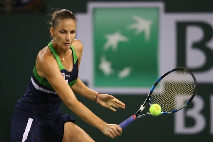 Karolina Pliskova of the Czech Republic plays a backhand against Garbine Muguruza of Spain on her way to a 7-6 (7/2), 7-6 (7/5) quarter final win at Indian Wells