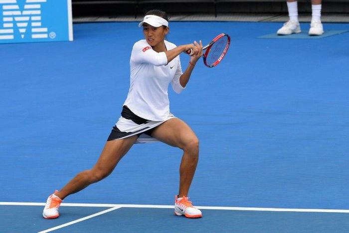 China's Zhang Shuai hits a return during the women's doubles second round match against India's Sania Mirza and the Czech Republic's Barbora Strycova on day five of the Australian Open tennis tournament in Melbourne on January 20, 2017