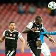 Besiktas' forward from Cameroon Vincent Aboubakar (C) scores in front of Napoli's defender from France Kalidou Koulibaly during the UEFA Champions League football match SSC Napoli vs Besiktas on October 19, 2016