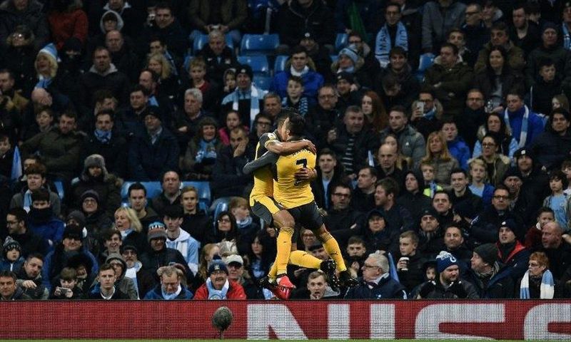 Arsenal's Theo Walcott (L) celebrates scoring with teammate Alexis Sanchez during their English Premier League football match against Manchester City