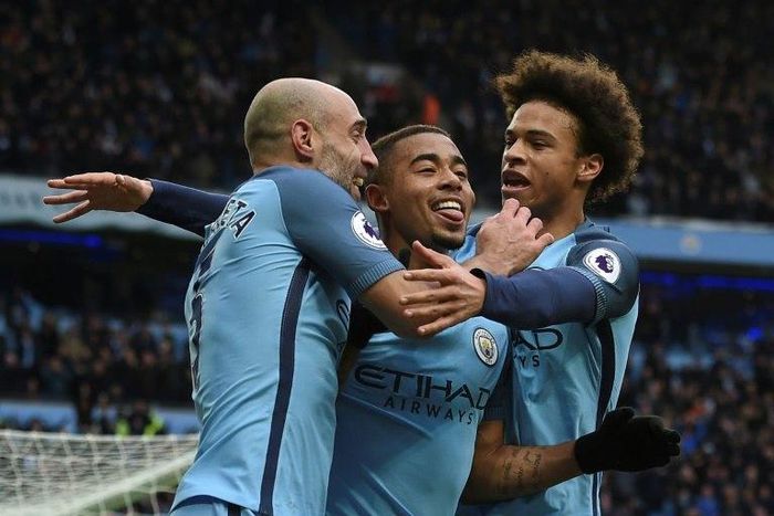Manchester City's Brazilian striker Gabriel Jesus (C) celebrates with Pablo Zabaleta (L) and Leroy Sane (R) after scoring their late winning goal against Swansea City on February 5, 2017