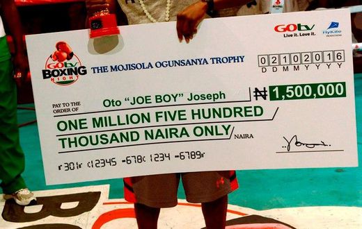 Joe Boy flaunts his trophy and cheque