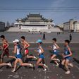 Competitors run through Kim Il-Sung square during the Pyongyang Marathon in the North Korean capital