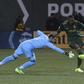Fanendo Adi (R) beats John Alvbage to score as the Portland Timbers beat Minnesota United 5-1 in Oregon