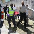 Paramedics carry a civilian wounded following a car bomb claimed by al Shabaab Islamist militants outside the president's palace on a stretcher from the scene of the explosion in the Somali capital of Mogadishu, August 30, 2016.