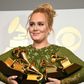 Adele poses in the press room with her five trophies, including the top two Grammys of Album and Record of the Year for her blockbuster hit "Hello" and the album "25"