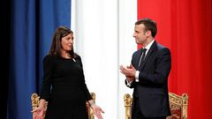 French President Emmanuel Macron (R) told Paris' Mayor Anne Hidalgo, "I'm right with you on your venture for the Olympics, Paralympics and the 2024 objective"