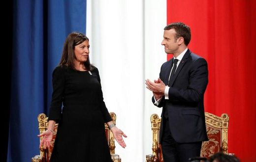 French President Emmanuel Macron (R) told Paris' Mayor Anne Hidalgo, "I'm right with you on your venture for the Olympics, Paralympics and the 2024 objective"