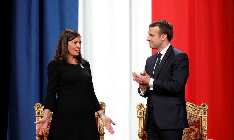 French President Emmanuel Macron (R) told Paris' Mayor Anne Hidalgo, "I'm right with you on your venture for the Olympics, Paralympics and the 2024 objective"