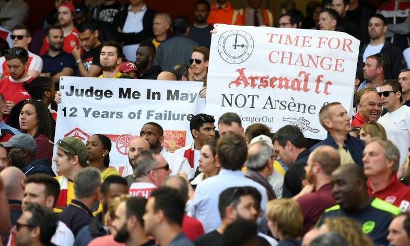 Fans hold up banners calling for a managerial change at Arsenal on May 21, 2017