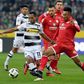 Moenchengladbach's forward Raffael (L) and Mainz' midfielder Jean Philippe Gbamin fight for the ball during their Bundesliga match in Moenchengladbach, on December 11, 2016