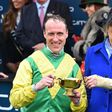 Jockey Robbie Power (L) and Irish trainer Jessica Harrington celebrate winning the Gold Cup with their horse Sizing John on the last day of the Cheltenham Festival at Cheltenham Racecourse in Gloucestershire, south-west England, on March 17, 2017