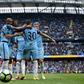 Manchester City's Nicolas Otamendi (2R) is mobbed by teammates as they celebrate scoring his team's fifth goal during their Premier League match against Crystal Palace at the Etihad Stadium in Manchester on May 6, 2017