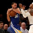 Stephen Curry of the Golden State Warriors (L) and Carmelo Anthony of the New York Knicks fight for the ball at Madison Square Garden on March 5, 2017 in New York City