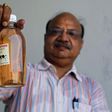 An Indian holding bottled Cow Urine