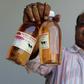 An Indian holding bottled Cow Urine