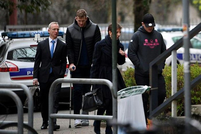 Grenoble's Irish centre Chris Farrell (2ndL) and Grenoble's Irish prop Denis Coulson (R) arrive on March 21, 2017 at the police station in Grenoble, French Alps