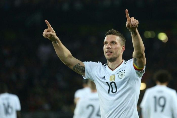 Germany's midfielder Lukas Podolski reacts after scoring during a friendly football match against England on March 22, 2017