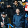 An Arsenal fan holds up a banner calling on Arsenal's French manager Arsene Wenger to quit during the English Premier League football match between Chelsea and Arsenal at Stamford Bridge in London on February 4, 2017