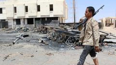 A member of the security team walks past the remains of a burnt car after a suicide car bomber hit a Libyan police station west of the besieged Islamic State stronghold of Sirte June 16, 2016. REUTERS/Stringer