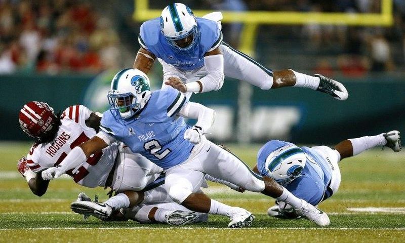 Darius Hoggins of the Louisiana-Lafayette Ragin Cajuns is tackled by Nico Marley (#2) of the Tulane Green Wave and Peter Woullard, top, during the first half of a game at Yulman Stadium on September 24, 2016 in New Orleans, Louisiana