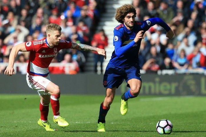 Middlesbrough's midfielder Adam Clayton vies with Manchester United's Marouane Fellaini (right) during their English Premier League match at Riverside Stadium in Middlesbrough on March 19, 2017