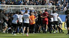 Bastia supporters invade the pitch to try to attack Lyon's Portuguese goalkeeper Anthony Lopes (in red) and others players during their warm-up prior to the French Ligue 1 match at the Armand Cesari stadium in Bastia, Corsica on April 16, 2017