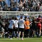 Bastia supporters invade the pitch to try to attack Lyon's Portuguese goalkeeper Anthony Lopes (in red) and others players during their warm-up prior to the French Ligue 1 match at the Armand Cesari stadium in Bastia, Corsica on April 16, 2017