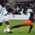 Olympique de Marseille striker Bafetimbi Gomis (L) scores a goal during the French football match against Montpellier at the Velodrome Stadium in Marseille on January 27, 2017
