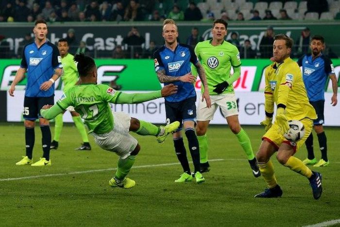Wolfsburg's midfielder Daniel Didavi (L) scores his team's second goal against Hoffenheim's goalkeeper Oliver Baumann on February 12, 2017