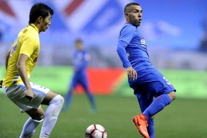 Shanghai Shenhua's Argentine striker Carlos Tevez (R) is in hot water after being spotted at Disneyland after missing a game with his Chinese club