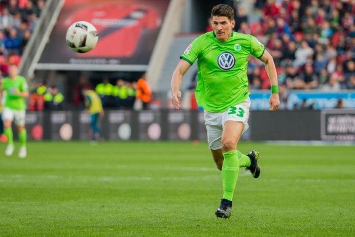 Wolfsburg's forward Mario Gomez runs with the ball against Bayer Leverkusen on April 2, 2017