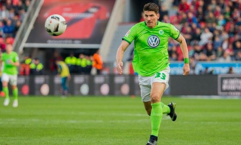 Wolfsburg's forward Mario Gomez runs with the ball against Bayer Leverkusen on April 2, 2017