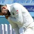 India's captain Virat Kohli holds his shoulder after he was injured while fielding during the first day of the third Test against Australia in Ranchi, on March 16, 2017