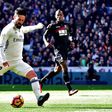 Real Madrid's midfielder Isco (L) kicks the ball to score against Granada on January 7, 2017