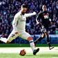 Real Madrid's midfielder Isco (L) kicks the ball to score against Granada on January 7, 2017