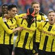 Dortmund's Pierre-Emerick Aubameyang (C) wears a mask as he celebrates with teammates after scoring against Schalke in Gelsenkirchen, western Germany, on April 1, 2017